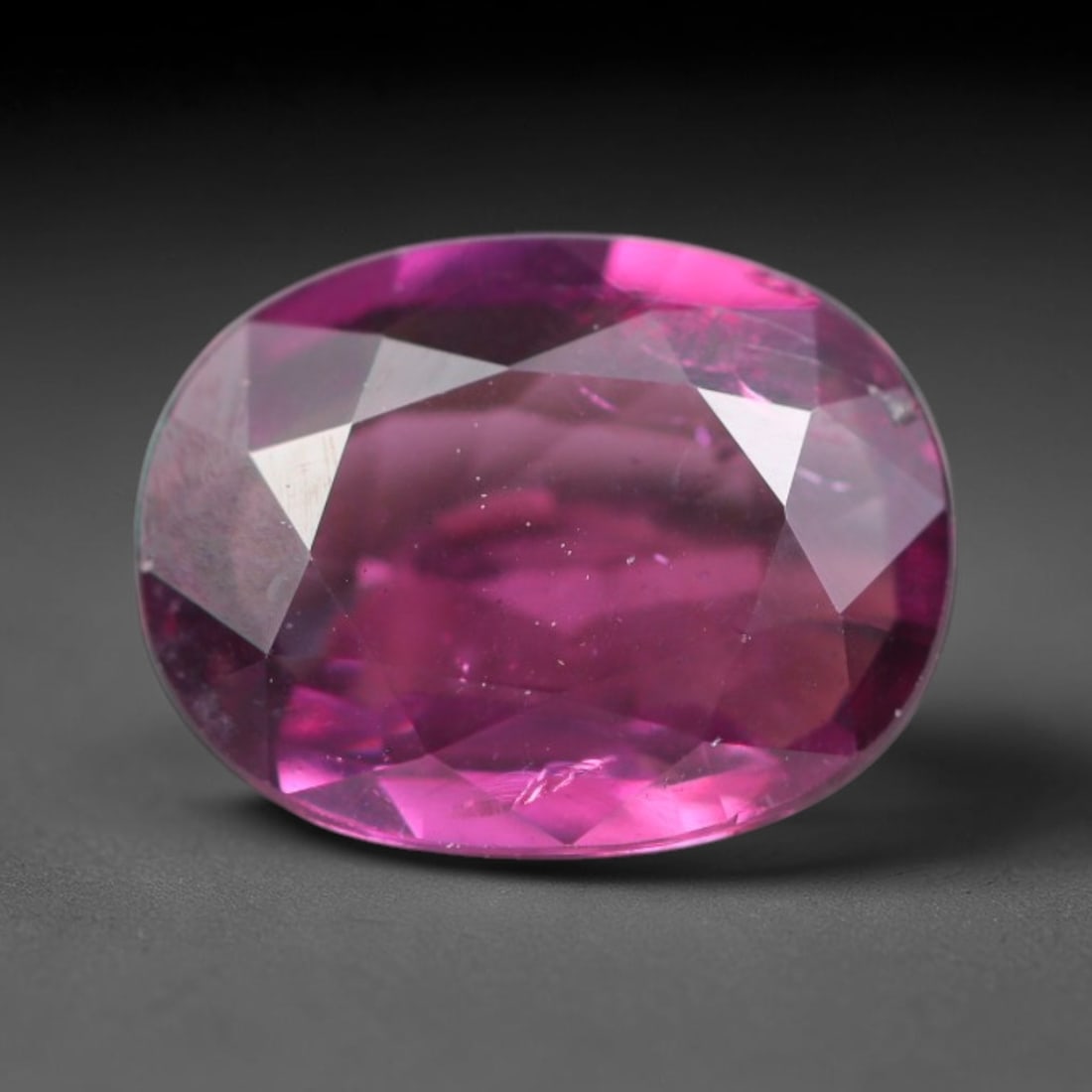 1.38ct Natural Tanzanian Rhodolite Grape Garnet Faceted Loose Gemstone, 84BA: This expertly faceted grape garnet, a scarce saturated purple-magenta rhodolite variant, features transparent crystal structure dotted with faint microscopic mineral specks within its precisely cut re