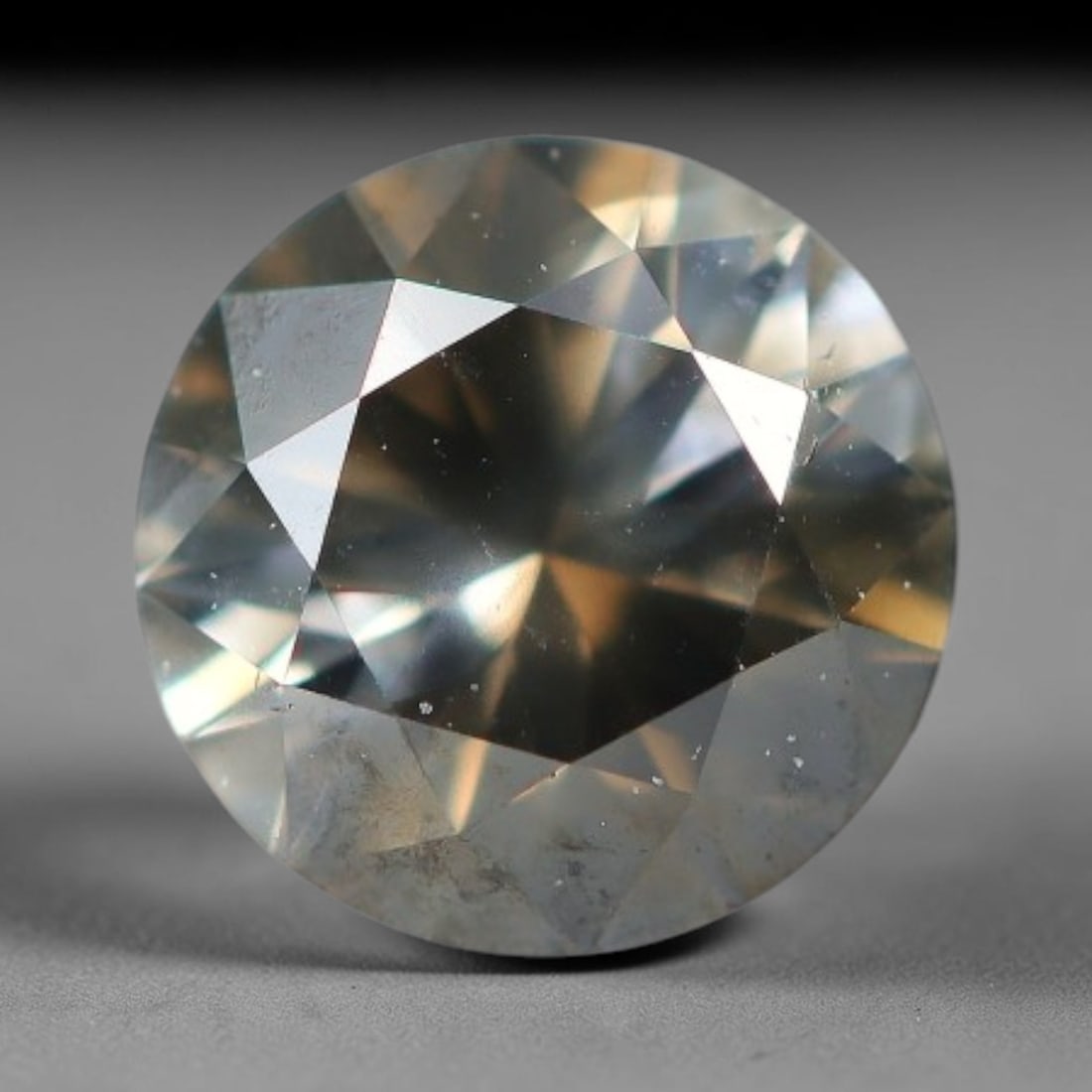 0.28ct Round Natural Fancy Greyish Yellow Diamond Loose Gemstone, 54BH: This polished natural round fancy diamond carries muted greyish-yellow blended tone, dotted with fine microscopic native mineral specks spread within its crystal interior, measured at calibrated dimen