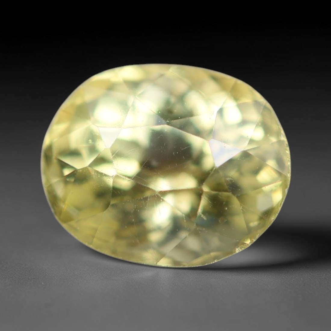 2.07ct Natural Mexican Lemon Yellow Faceted Apatite Loose Gemstone, 71BC: This expertly faceted yellow apatite holds translucent pale lemon yellow crystal structure with faint tiny internal mineral specks and subtle fine linear markings visible beneath its precisely polishe