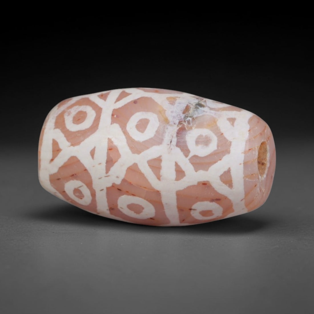 Antique Sino-Himalayan Region Etched Carnelian Bead, 1EH: Antique etched carnelian bead originating from the Sino-Himalayan region. Exhibits characteristic surface patina and traditional etched white decoration. Dimensions: 15x9mm, fully pierced for suspensi