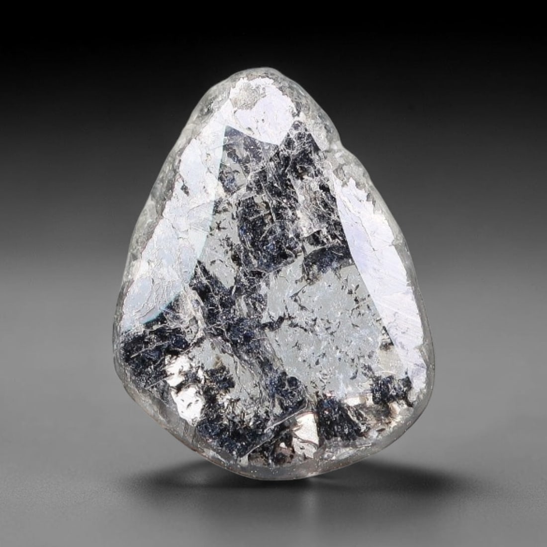 0.31ct Natural Fancy Diamond Slice, 56BG: This unique natural diamond slice features a delicate hand-executed rose cut surface, showcasing captivating pictorial mineral inclusions trapped within the diamond matrix. Measuring 7.1x5.4x0.7mm, th