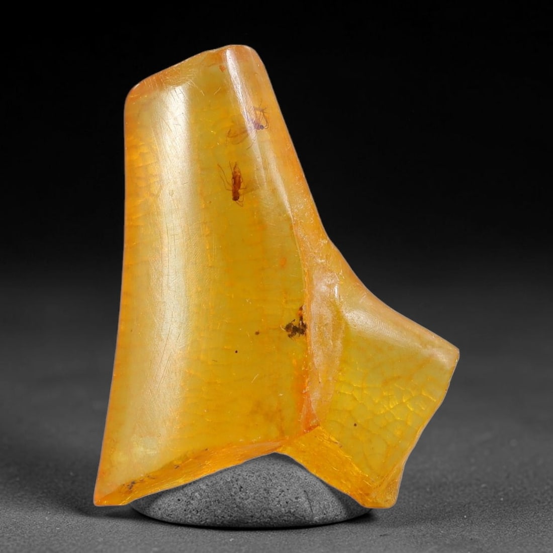 8.98ct Natural Baltic Polished Loose Freeform Amber Gemstone, 89FL: This smoothly polished freeform amber piece carries warm translucent organic clarity with fine natural fossil flecks and tiny mineral inclusions suspended throughout its 27x20x7mm flowing unstructured