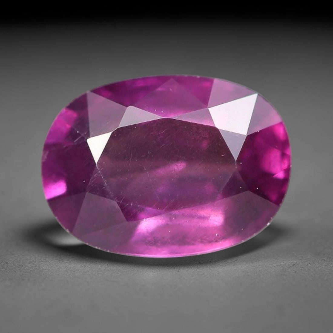 1.10ct Natural Tanzanian Rhodolite Grape Garnet Faceted Loose Gemstone, 90BF: This expertly faceted grape garnet, a scarce saturated purple-magenta rhodolite variant, features transparent crystal structure dotted with faint microscopic mineral specks within its precisely cut re