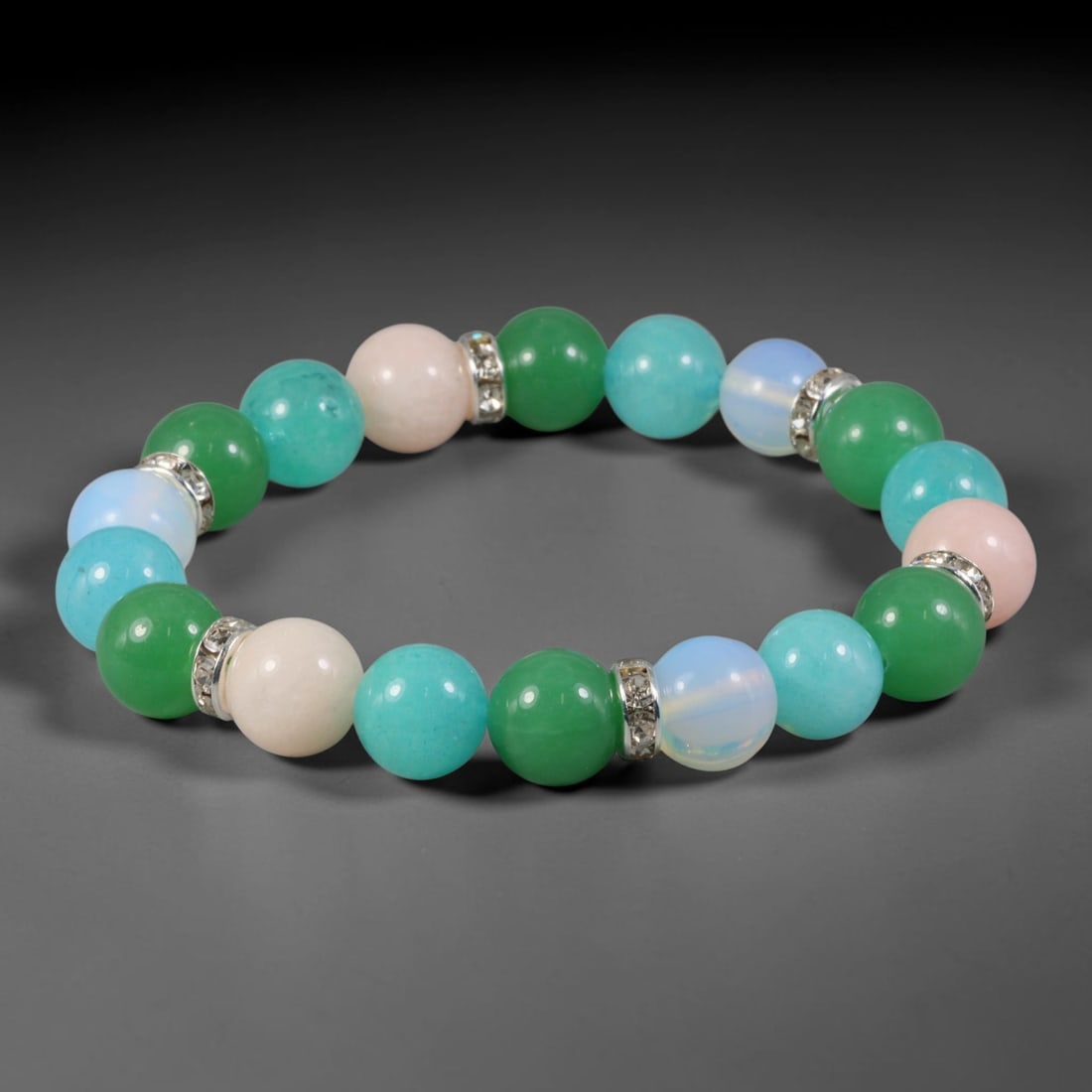 Natural Mixed Stone Beaded Bracelet - Polished Round Bead Strand, 57FA: This stretch bracelet features uniformly spherical polished natural mineral beads separated by silvered metal spacers inlaid with clear crystalline details. The hard stone beads display natural colour