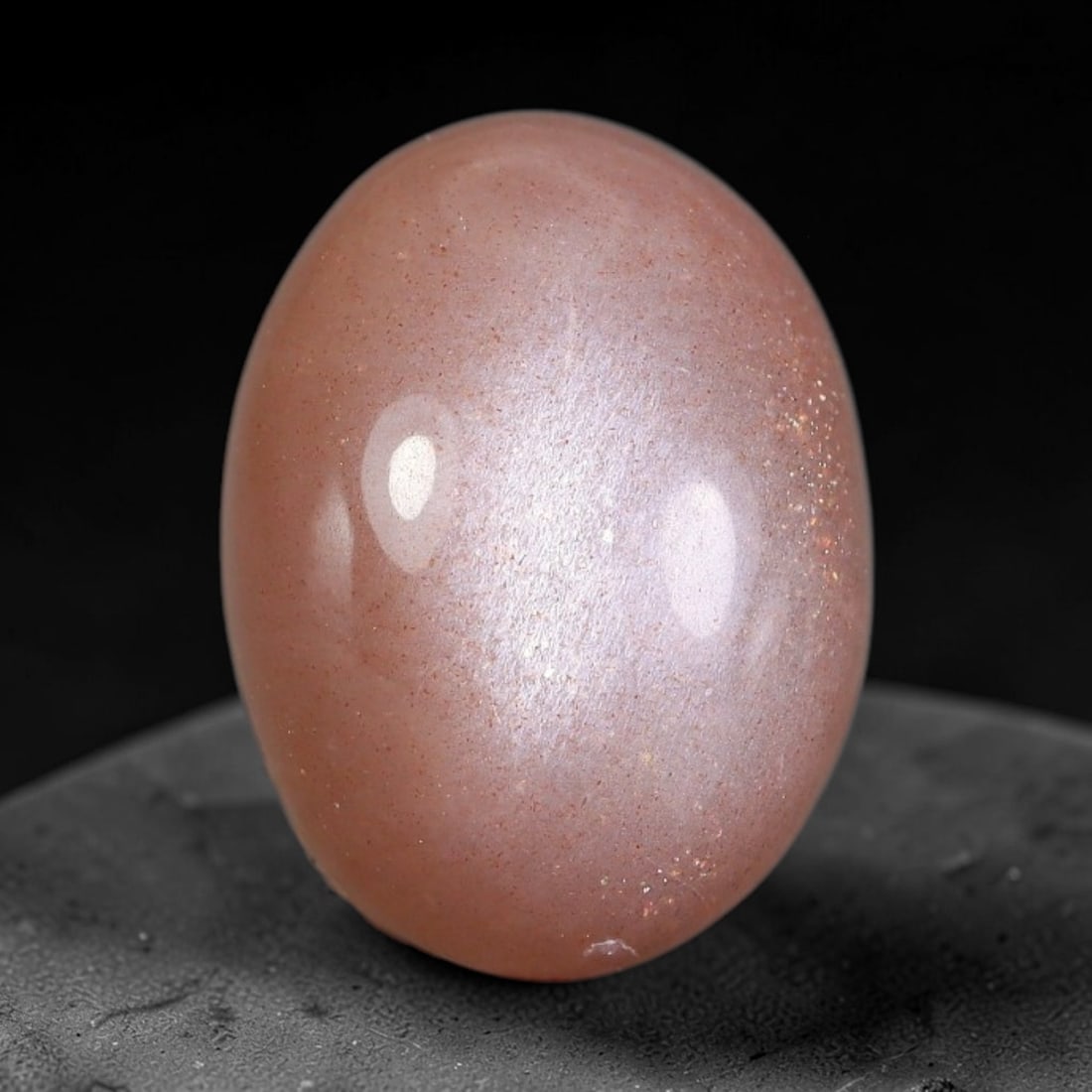 8.88 Carats Natural Ceylon Warm Peach Moonstone Loose Gemstone, 1AG: This natural Ceylon moonstone has dimension measurements of 15.2x11.2x6.8mm, showcasing a smooth warm peach base tone paired with subtle soft adularescent sheen that glides gently across the polished 