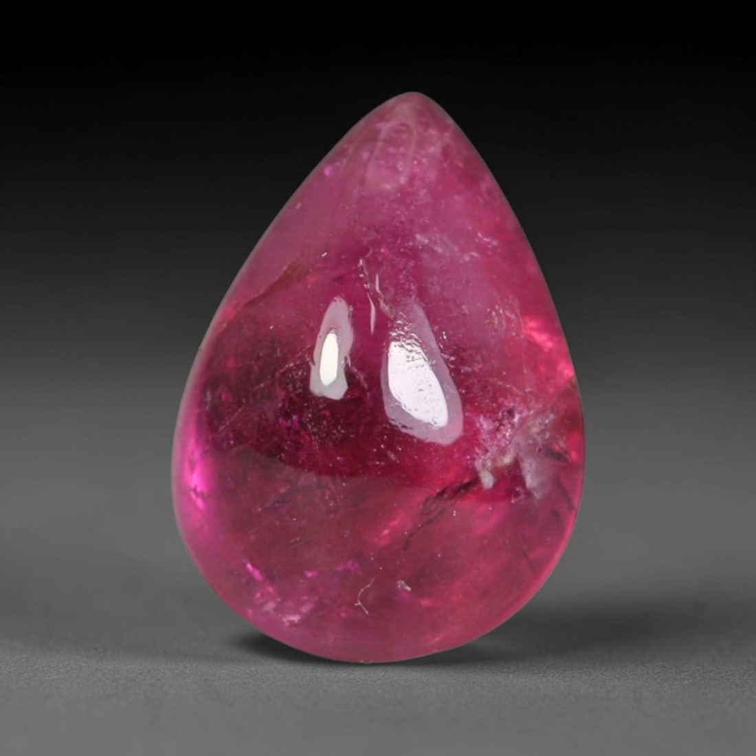 1.94ct Natural Brazilian Rubellite Tourmaline Cabochon Loose Gemstone, 44BC: This smoothly polished cabochon rubellite tourmaline features layered saturated pink-red body saturation with dense natural crystalline mineral flecks and fine internal fracture markings concentrated 