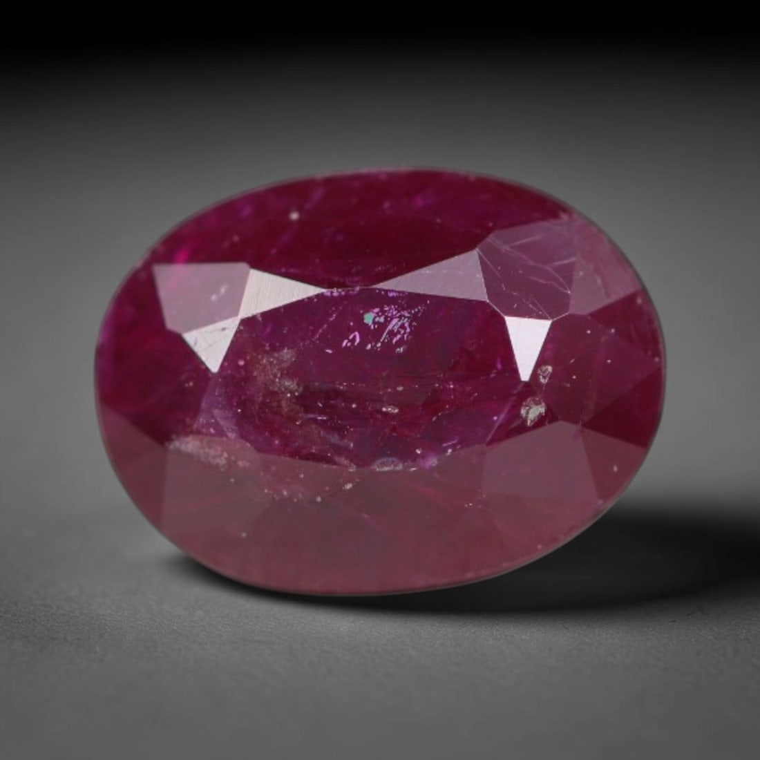 1.10ct Natural Tanzanian Longido Deep Crimson Red Faceted Ruby Loose Gemstone, 9BD: This expertly faceted Longido ruby features a rich deep crimson red body tone with distinct natural linear mineral striations, scattered pale mineral deposits and minor dark mineral flecks visible wit