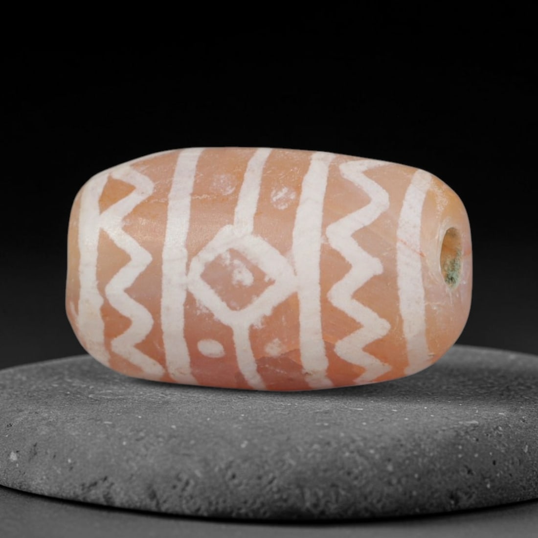 Antique Sino-Himalayan Region Etched Carnelian Bead, 93EG: Antique etched carnelian bead originating from the Sino-Himalayan region. Exhibits characteristic surface patina and traditional etched white decoration. Dimensions: 14x9mm, fully pierced for suspensi