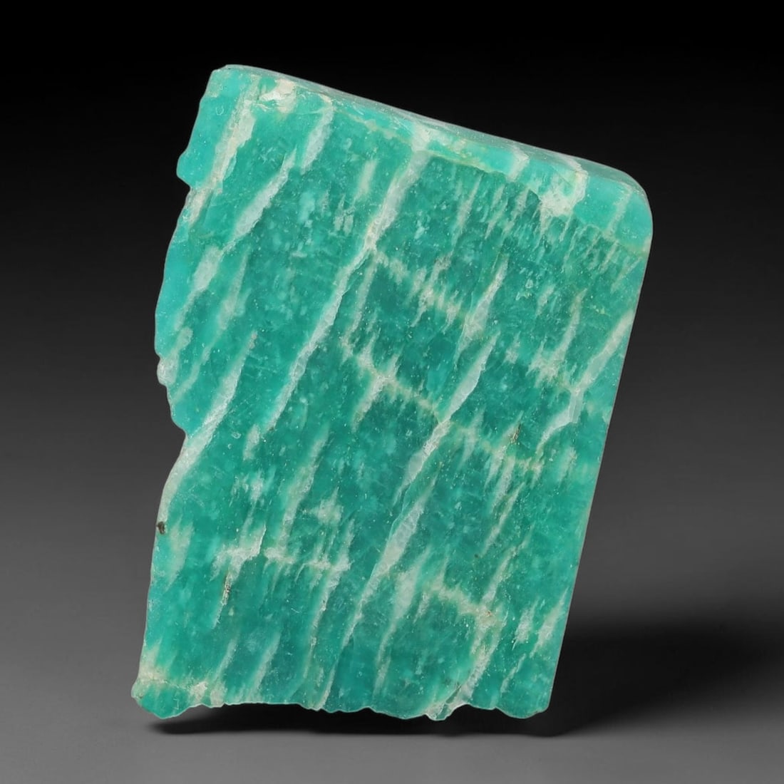 65ct Natural Russian Ural Amazonite Slab Rough, 81EB: This intact amazonite slab features distinct parallel mineral banding running uniformly across its naturally split flat surface within 34x25x7mm slab dimensions, retaining unmodified natural geologica