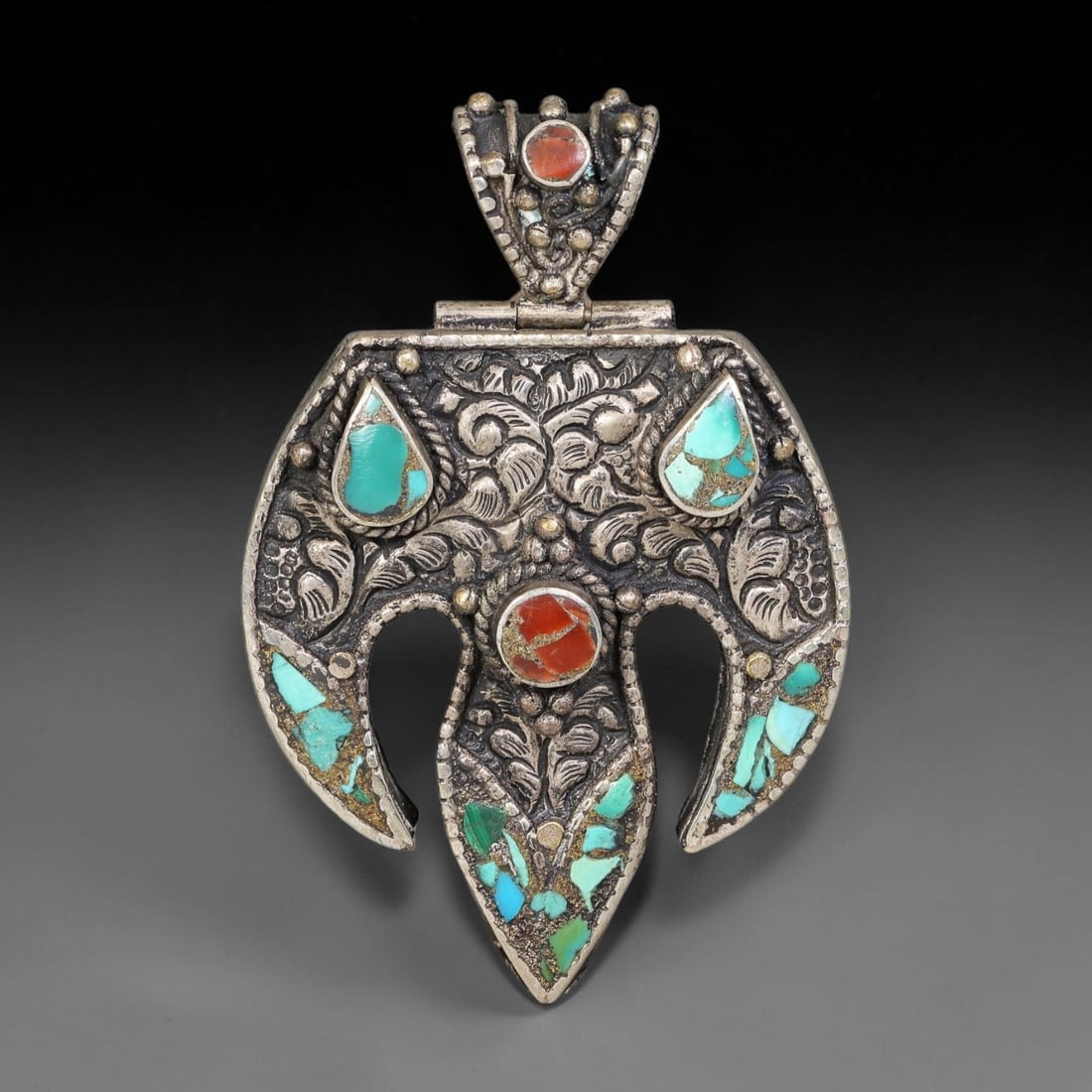 Vintage Tibetan Silver Plated Stone Inlay Pendant, 87BY: Vintage Tibetan silver plated locket-style pendant measuring 7 x 4.5 cm. The metal surface features elaborate embossed decorative detailing and is set with multiple natural mineral inlays. Built with 