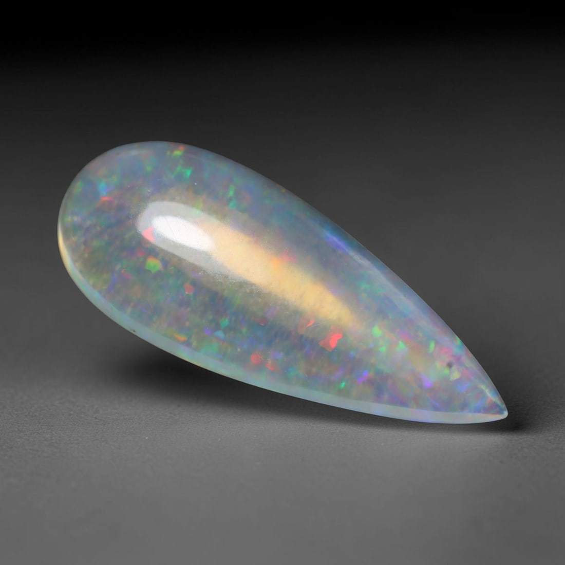 11.56ct Natural Ethiopian Welo Opal Cabochon Loose Gemstone, 23BY: This smoothly polished cabochon is genuine natural Ethiopian Welo opal. The translucent base hosts vivid multi-coloured play-of-colour, displaying dynamic flashes of multi color that shift as the view