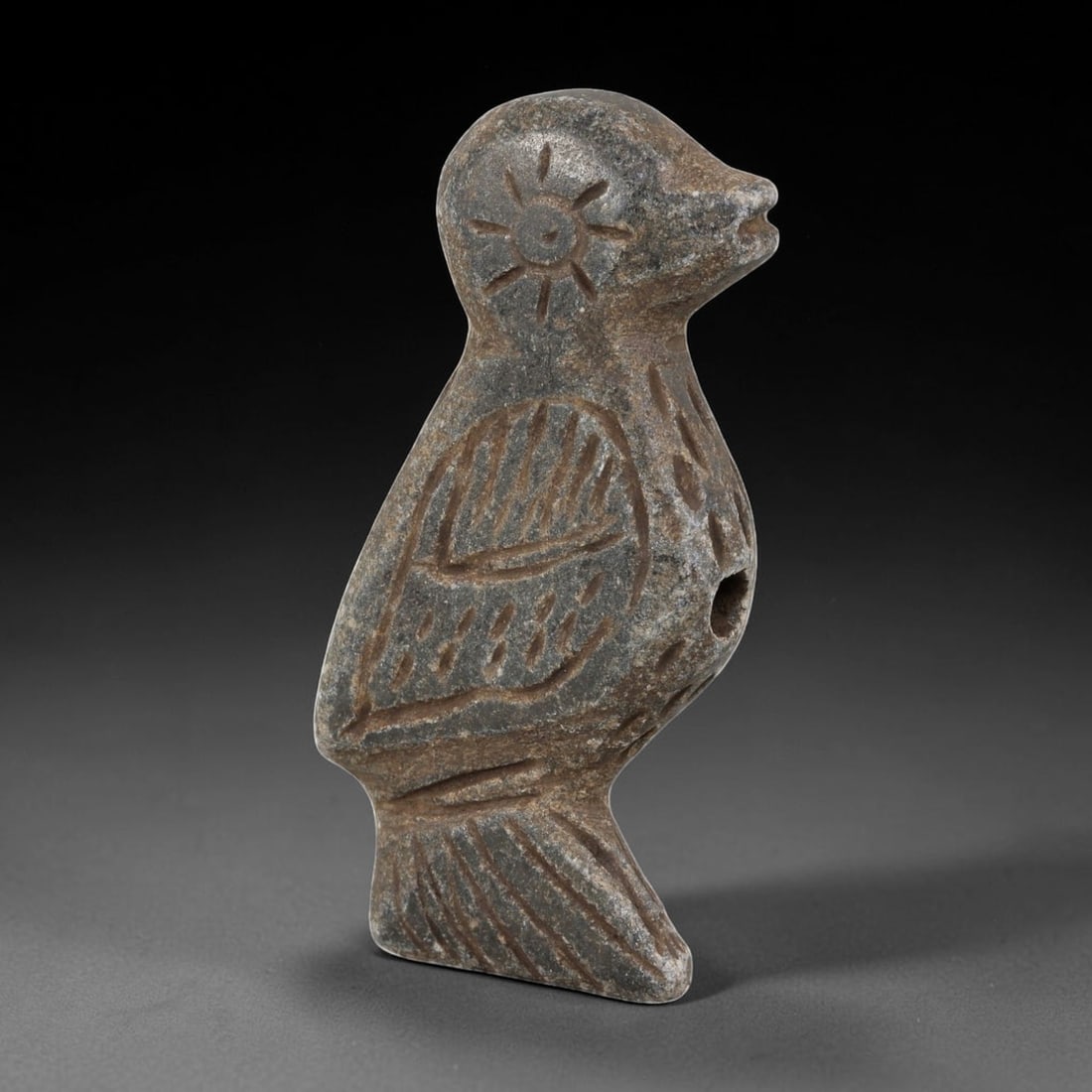 Antique Medieval Silk Road Schist Bird Effigy Artifact, 89AN: Carved from weathered grey schist, this stylized bird effigy is characteristic of medieval Silk Road craftsmanship. The figure features a sunburst motif incised on the head, with linear carvings detai