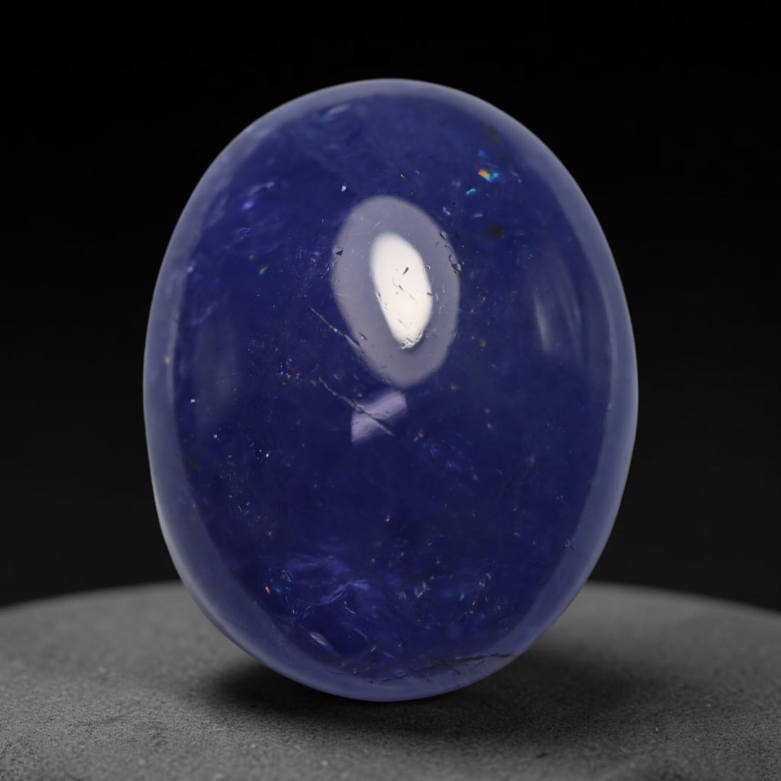 25.14ct Natural Tanzanian Tanzanite Oval Cabochon Loose Gemstone, 71BZ: This smoothly polished oval cabochon is natural tanzanite sourced exclusively from Tanzania, the only known origin for this rare gemstone. It features rich, saturated violet-blue colour across the tra