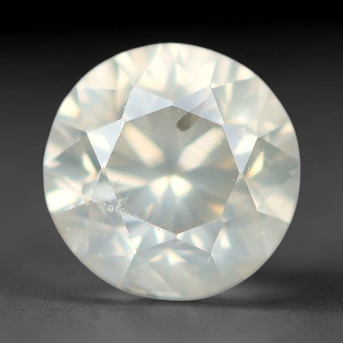 0.23ct Round Natural Fancy Greenish Yellow Diamond Loose Gemstone, 59BH: This polished natural round fancy diamond displays a delicate greenish-yellow base tone, with scattered fine native mineral specks distributed within its crystalline interior, measured at calibrated d