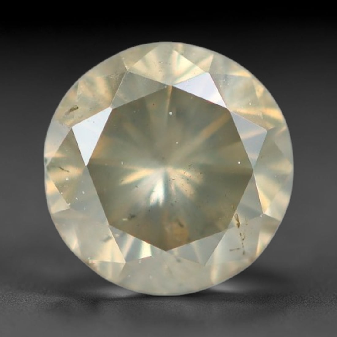 0.27ct Round Natural Fancy Greenish Yellow Diamond Loose Gemstone, 44BH: This polished natural round fancy diamond displays a delicate greenish-yellow base tone, with scattered fine native mineral specks distributed within its crystalline interior, measured at calibrated d