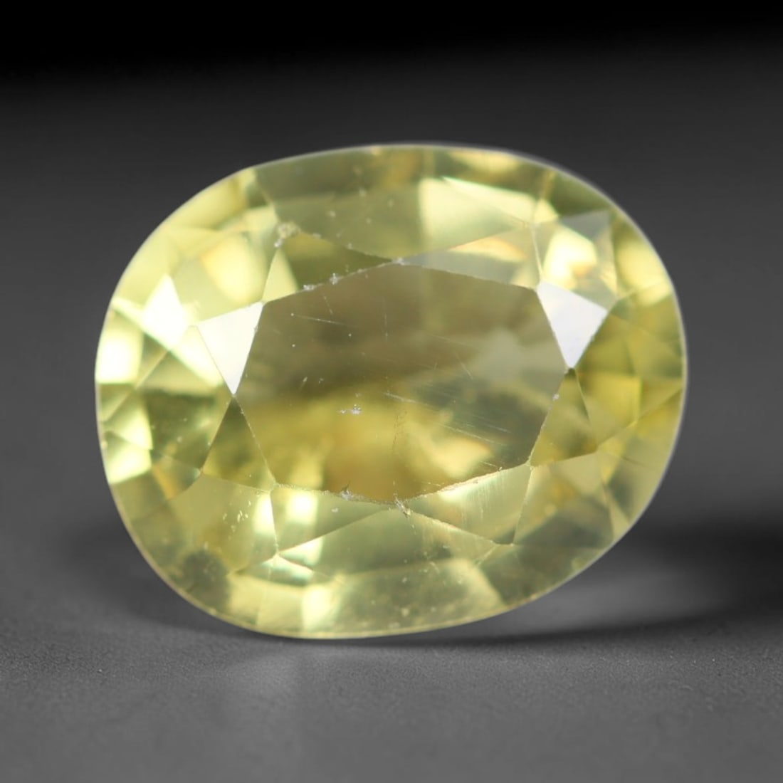 2.00ct Natural Mexican Lemon Yellow Faceted Apatite Loose Gemstone, 91AR: This expertly faceted yellow apatite holds translucent pale lemon yellow crystal structure with faint tiny internal mineral specks and subtle fine linear markings visible beneath its precisely polishe