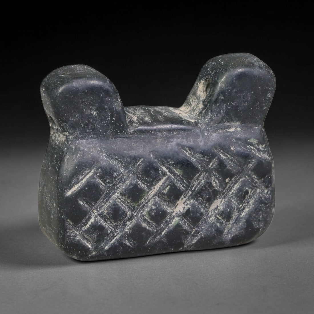 Ancient Sasanian Persian Serpentine Patterned Talisman Amulet Bead (224-651 CE), 12EC: This antique non-zoomorphic talisman amulet bead carved from serpentine originates from the Sasanian Persian Empire, crafted as a protective wearable charm marked with symbolic incised ornamentation. 
