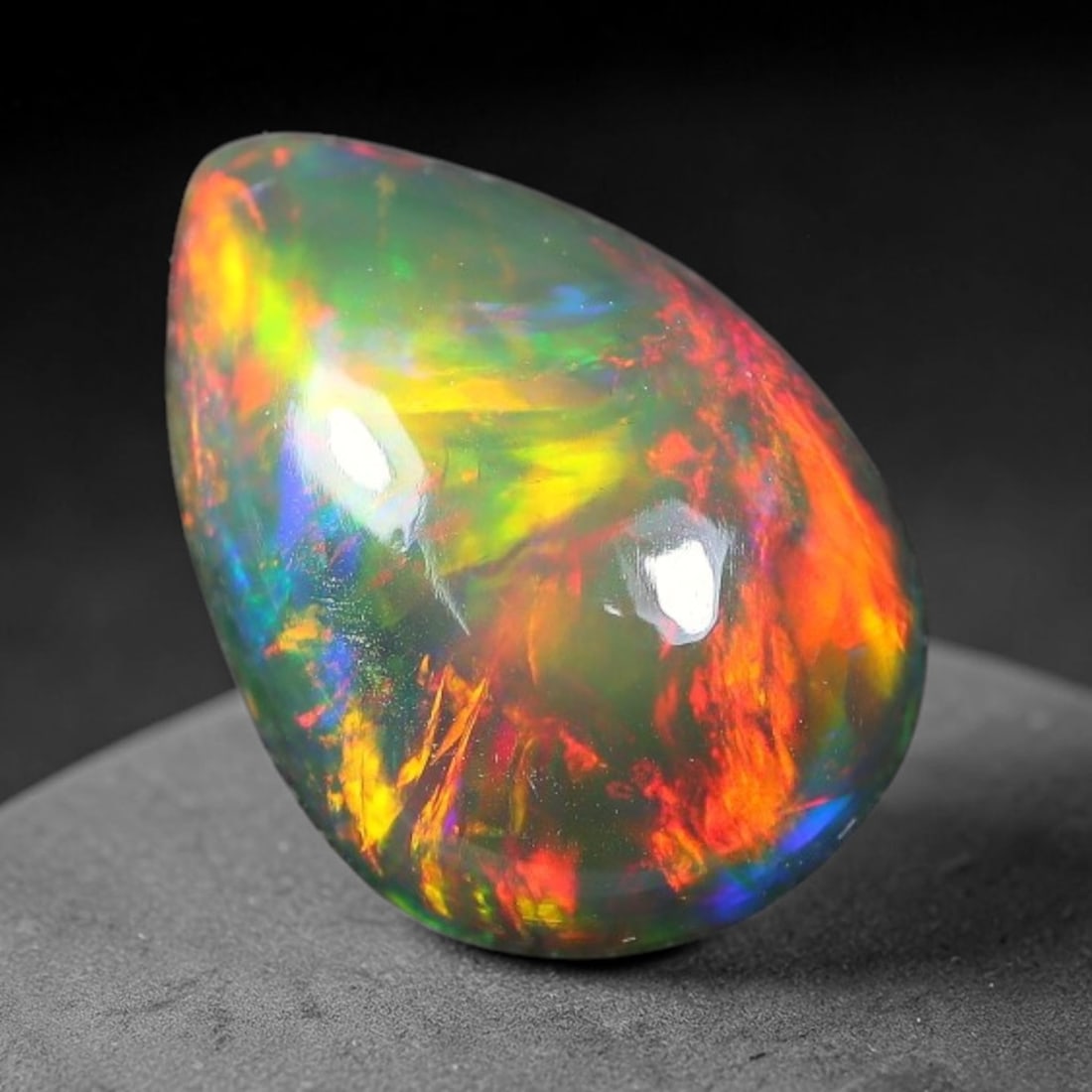 1.86ct Natural Ethiopian Welo Black Smoked Opal Cabochon Loose Gemstone, 8FX: This fully polished Ethiopian Welo opal features a dark smoked base with vivid, sweeping play-of-color shifting across its glossy dome surface, measured at 11x7x4mm. The black smoke treatment deepens 