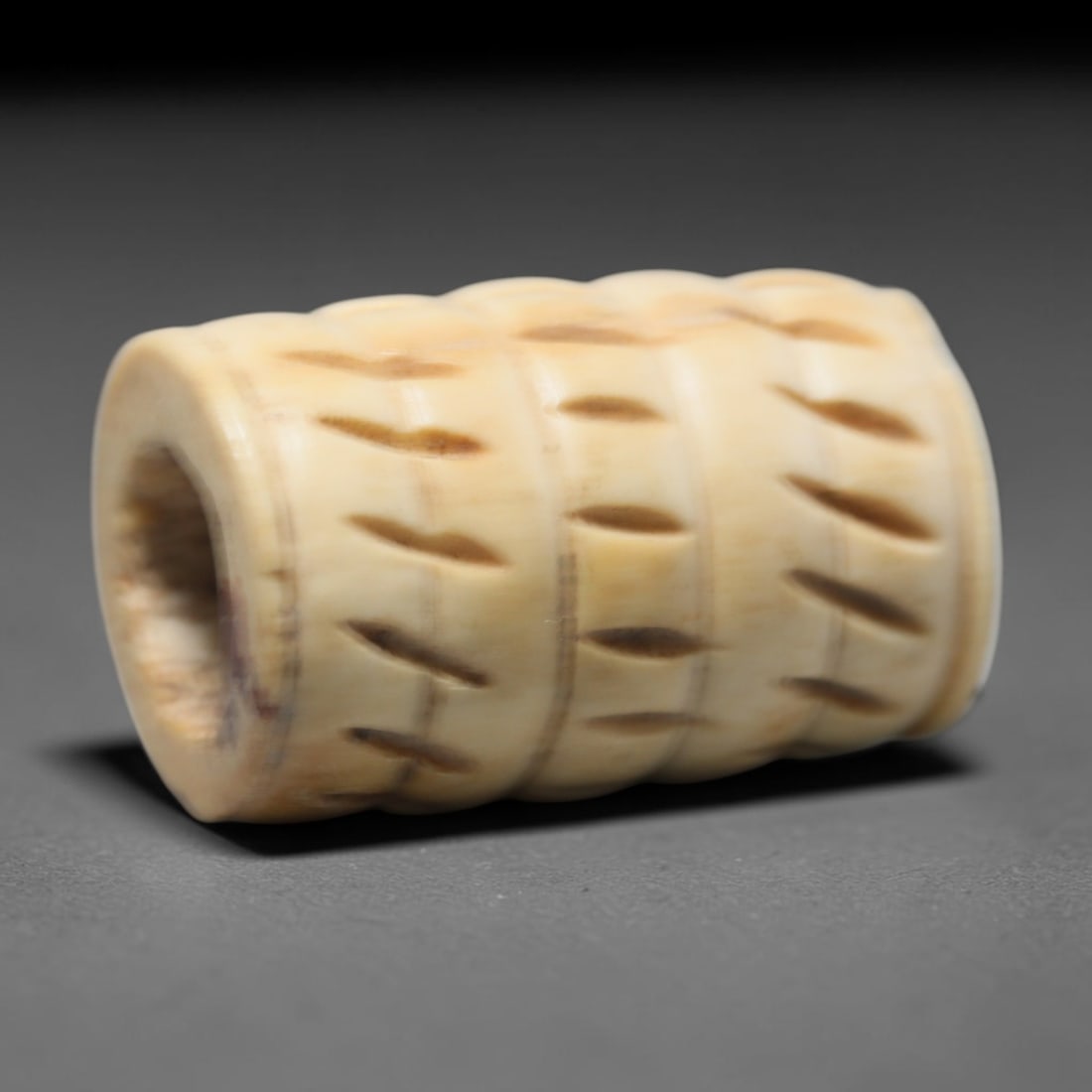 Antique Sino-Siberian Steppe Nomadic Craft Stag Antler Carved Cylinder Bead (Post 1850s), 78FV: Single bead carved from natural stag antler, originating from Sino-Siberian Steppe Nomadic craft traditions, post 1850s. Measuring 3x2cm, the piece features detailed surface carving and carries warm n