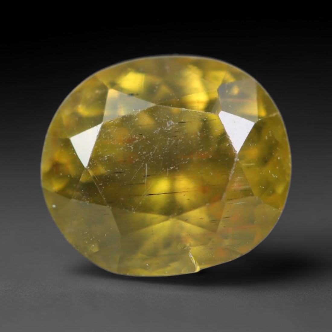 1.62ct Natural Mexican Lemon Yellow Faceted Apatite Loose Gemstone, 29BC: This expertly faceted yellow apatite holds translucent pale lemon yellow crystal structure with faint tiny internal mineral specks and subtle fine linear markings visible beneath its precisely polishe