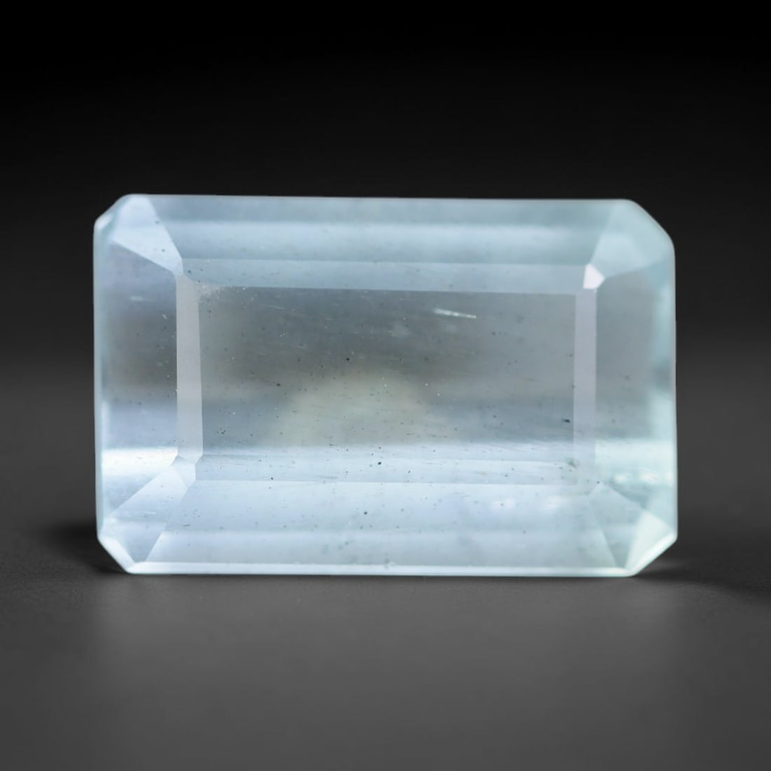 4.72ct Natural Brazilian Soft Sky Blue Faceted Aquamarine Loose Gemstone, 8AS: This expertly faceted aquamarine carries a gentle soft sky blue translucent body with faint fine natural internal mineral markings visible through its polished reflective facets within its 13.2x6.8x5.