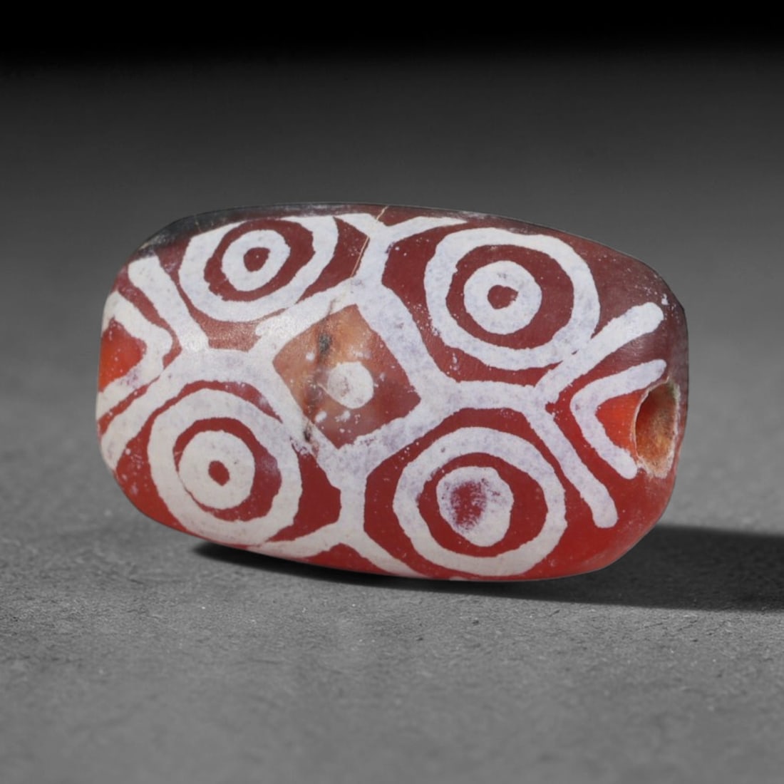 Antique Sino-Himalayan Region Etched Carnelian Bead, 77EG: Antique etched carnelian bead originating from the Sino-Himalayan region. Exhibits characteristic surface patina and traditional etched white decoration. Dimensions: 15x9mm, fully pierced for suspensi