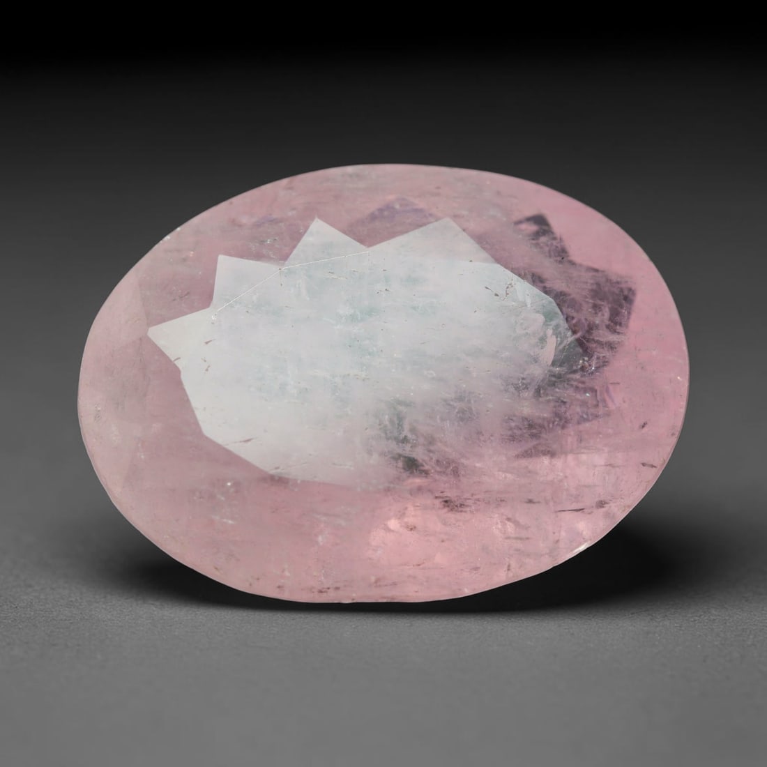 24.18ct Natural Brazilian Morganite Oval Faceted Loose Gemstone, 24BY: This precision oval faceted gemstone is natural morganite sourced from Brazil. It carries soft pastel pink colouration with gentle natural tonal variation throughout the transparent crystal matrix. Ca
