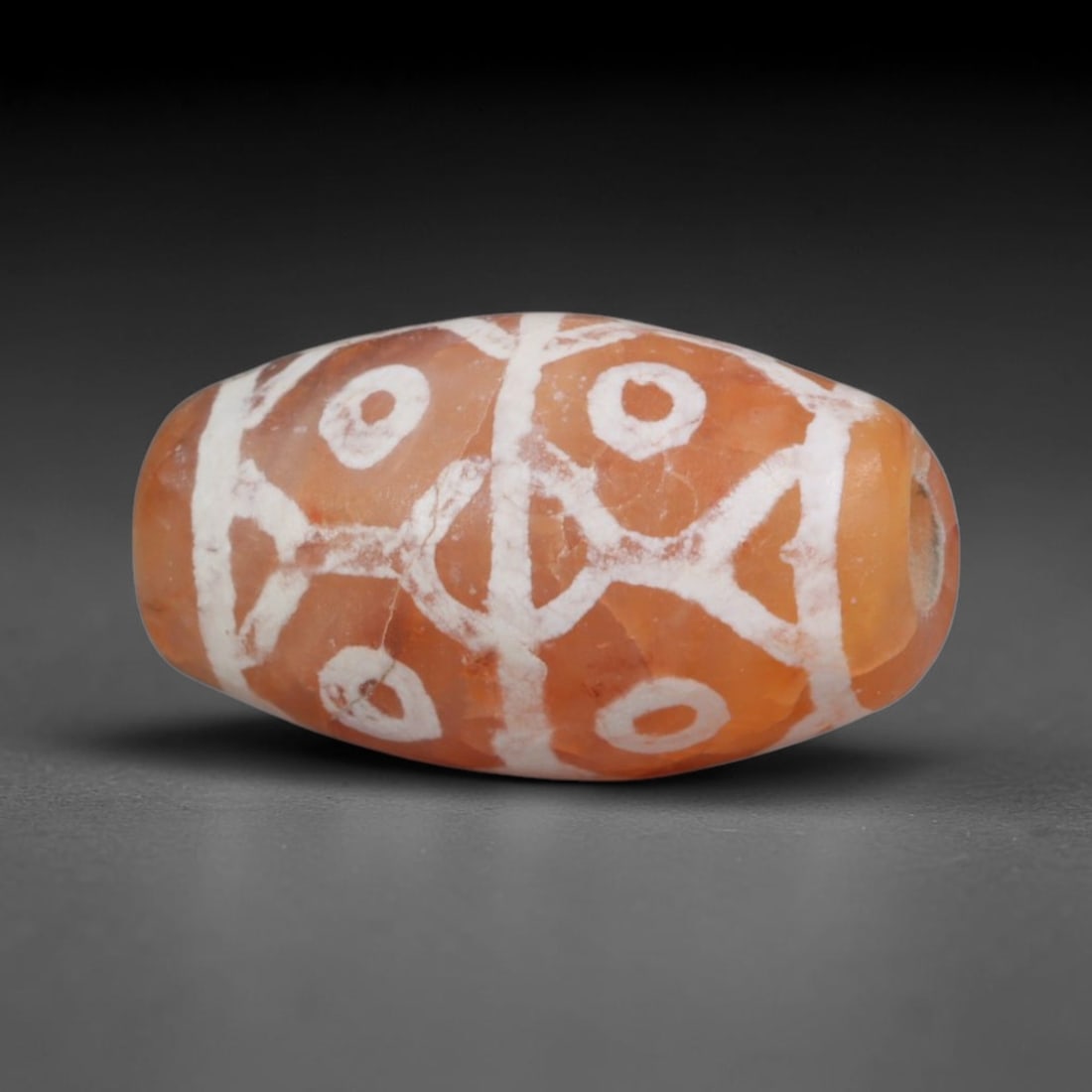 Antique Sino-Himalayan Region Etched Carnelian Bead, 2EH: Antique etched carnelian bead originating from the Sino-Himalayan region. Exhibits characteristic surface patina and traditional etched white decoration. Dimensions: 15x9mm, fully pierced for suspensi