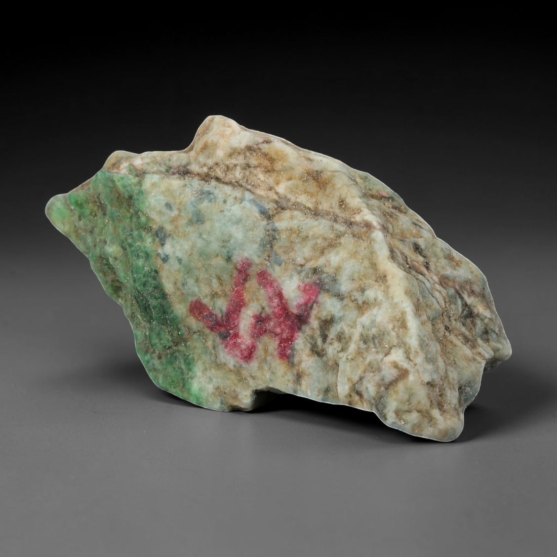 185Ct Natural Type A Burmese Jadeite Jade Rough Stone - Multi-Color Raw Material, 41EA: This is a natural, unpolished rough stone of Type A Burmese jadeite jade, weighing 185 carats and measuring 5.5x3cm. The stone displays a striking multi-color pattern with vibrant green patches, earth