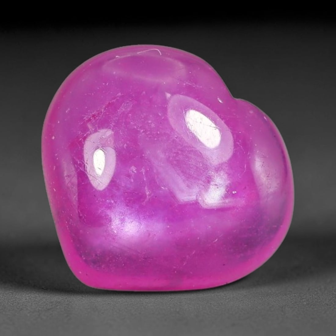 5.48 Carats Natural Mozambique Hot Pink Ruby Loose Gemstone, 57FE: This heart shaped Mozambique ruby cabochon measures 11.5x10.6x4.1mm, showcasing a vivid saturated hot pink body paired with stunning natural hexagonal crystal growth banding that forms a distinct geom