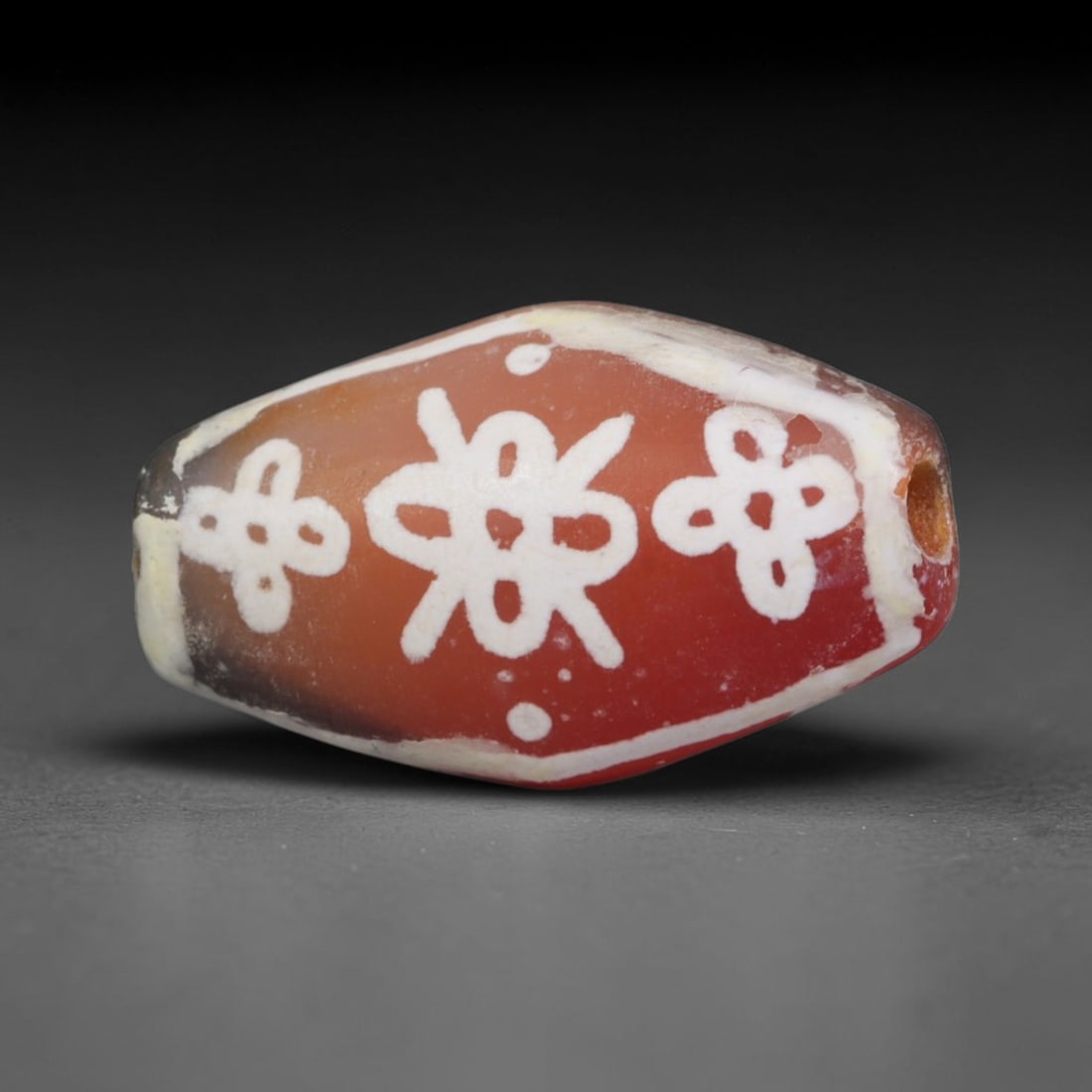 Antique Sino-Himalayan Region Etched Carnelian Bead, 71EG: Antique etched carnelian bead originating from the Sino-Himalayan region. Exhibits characteristic surface patina and traditional etched white decoration. Dimensions: 18x10mm, fully pierced for suspens