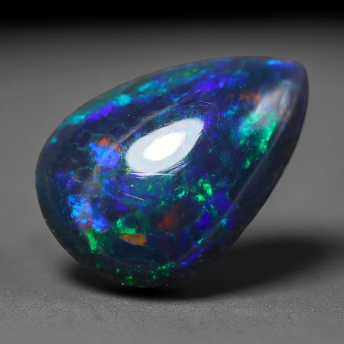 4.93ct Natural Ethiopian Welo Black Smoked Opal Cabochon Loose Gemstone, 72BY: This fully polished Ethiopian Welo opal features a dark smoked base with vivid, sweeping play-of-color shifting across its glossy dome surface, measured at 16x11x6mm. The black smoke treatment deepens