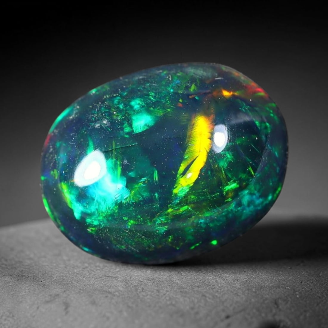 2.44ct Natural Ethiopian Welo Black Smoked Opal Cabochon Loose Gemstone, 74FX: This fully polished Ethiopian Welo opal features a dark smoked base with vivid, sweeping play-of-color shifting across its glossy dome surface, measured at 11x8x5mm. The black smoke treatment deepens 