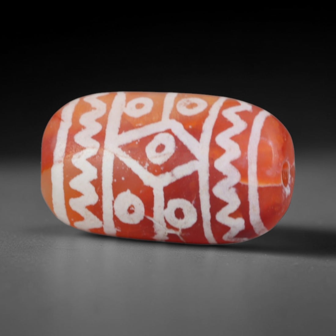 Antique Sino-Himalayan Region Etched Carnelian Bead, 92EG: Antique etched carnelian bead originating from the Sino-Himalayan region. Exhibits characteristic surface patina and traditional etched white decoration. Dimensions: 16x10mm, fully pierced for suspens