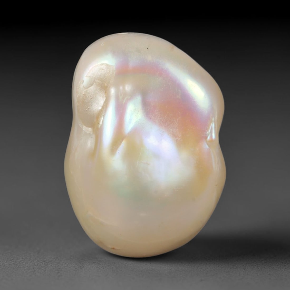 Natural Freshwater Keshi Pearl - Iridescent Baroque Pearl Ornament, 55AE: A natural freshwater keshi pearl with organic asymmetrical baroque shaping, exhibiting soft creamy blush base tones with shifting pastel pink, lavender and pale gold iridescent luster across its smoot