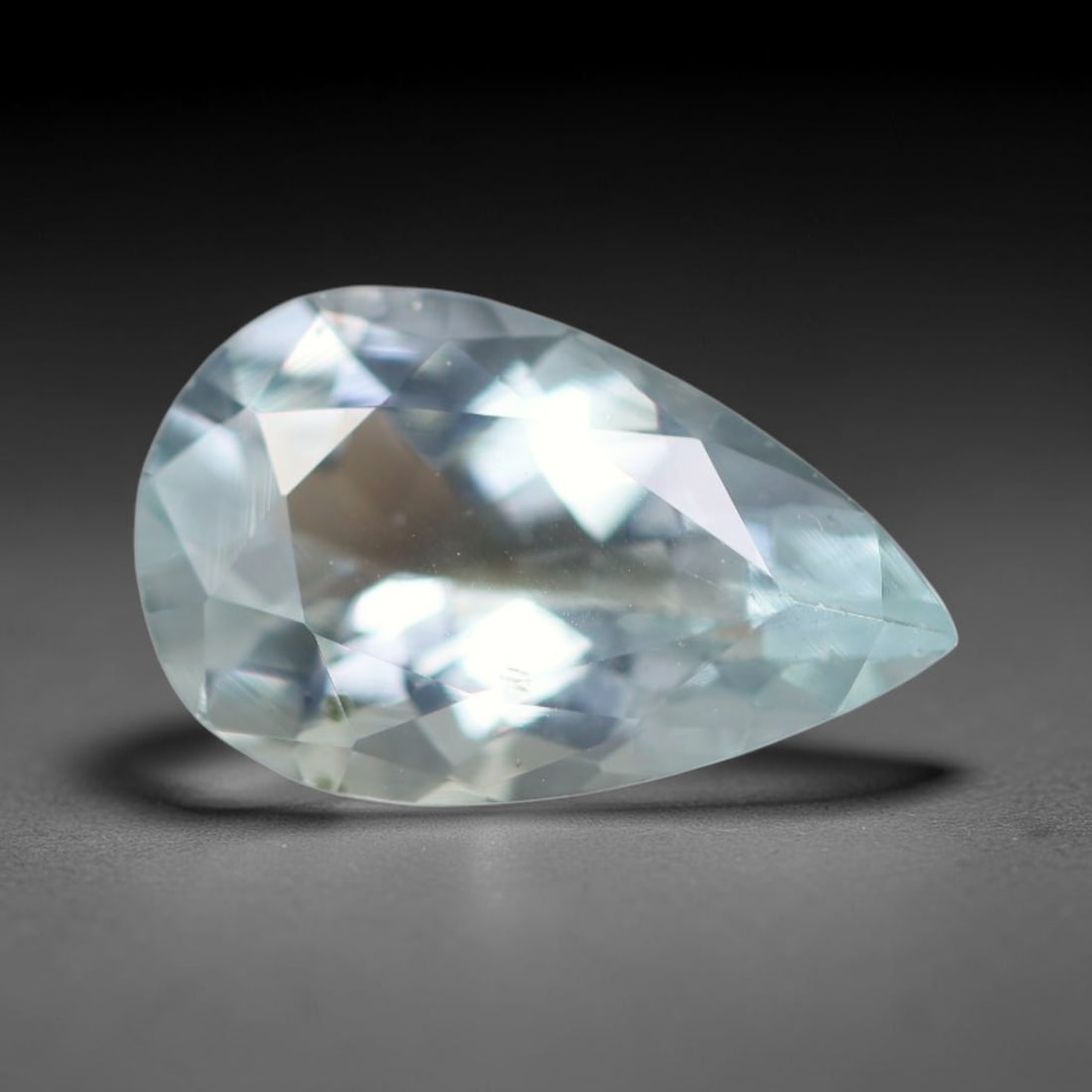 1.54ct Natural Brazilian Sky Blue Faceted Aquamarine Loose Gemstone, 8BC: This precisely faceted aquamarine boasts clear translucent pale sky blue body tone with subtle thin mineral needle and tiny scattered crystalline specks visible within its polished reflective planes i