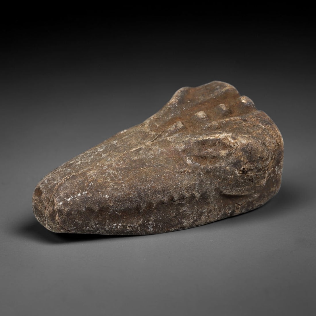 Ancient Medieval Near Eastern Stone Zoomorphic Head (600-1100 CE), 13EK: This antique stone zoomorphic head originates from medieval Near Eastern cultural tradition, created for ceremonial and talismanic function. The dense stone bears heavy agerelated patina, surface eros