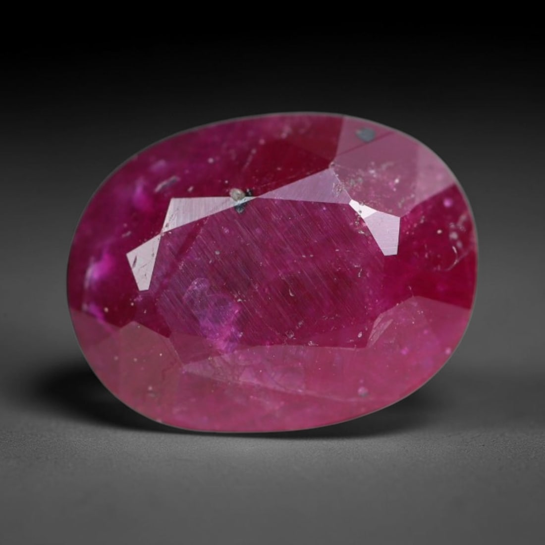 1.56ct Natural Tanzanian Longido Deep Crimson Red Faceted Ruby Loose Gemstone, 89BC: This expertly faceted Longido ruby features a rich deep crimson red body tone with distinct natural linear mineral striations, scattered pale mineral deposits and minor dark mineral flecks visible wit