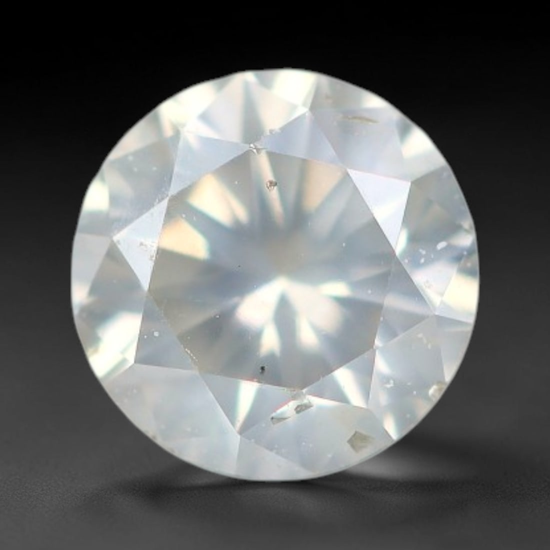 0.25ct Round Natural Fancy Greenish Yellow Diamond Loose Gemstone, 39BH: This polished natural round fancy diamond displays a delicate greenish-yellow base tone, with scattered fine native mineral specks distributed within its crystalline interior, measured at calibrated d