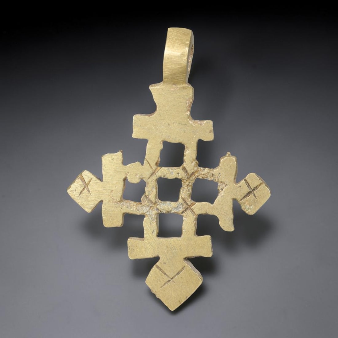 Vintage Ethiopian Copper Alloy Cross Pendant, 18EJ: Crafted from copper alloy, this traditional Ethiopian cross pendant features integrated suspension loop for wear. Shows authentic surface patina consistent with vintage origin. Dimensions: 4.7x3.5cm. 