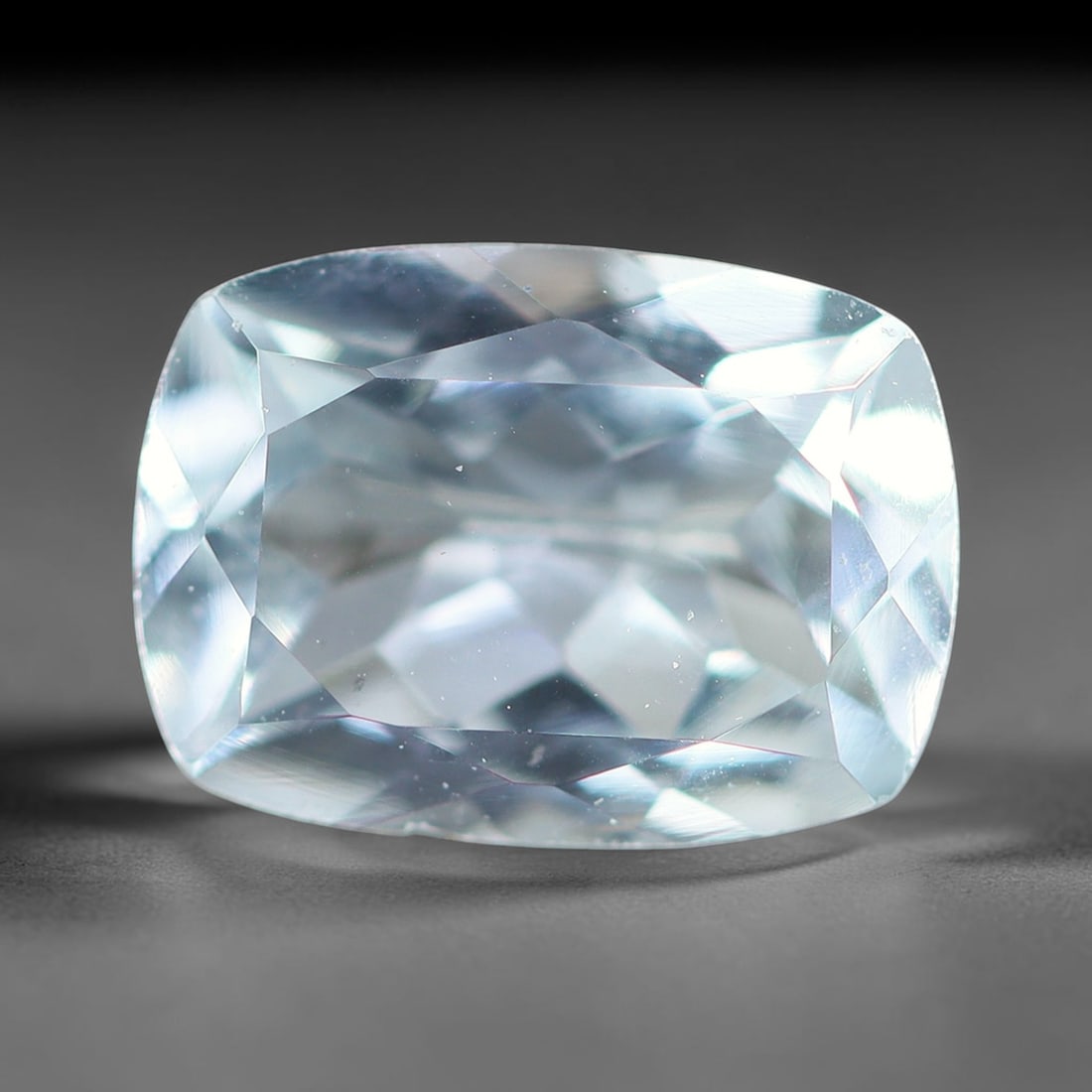 1.57ct Natural Brazilian Sky Blue Faceted Aquamarine Loose Gemstone, 3BF: This precisely faceted aquamarine boasts clear translucent pale sky blue body tone with subtle thin mineral needle and tiny scattered crystalline specks visible within its polished reflective planes i