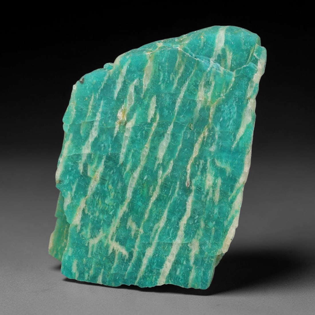 95ct Natural Russian Ural Amazonite Slab Rough, 84EB: This intact amazonite slab features distinct parallel mineral banding running uniformly across its naturally split flat surface within 44x31x7mm slab dimensions, retaining unmodified natural geologica
