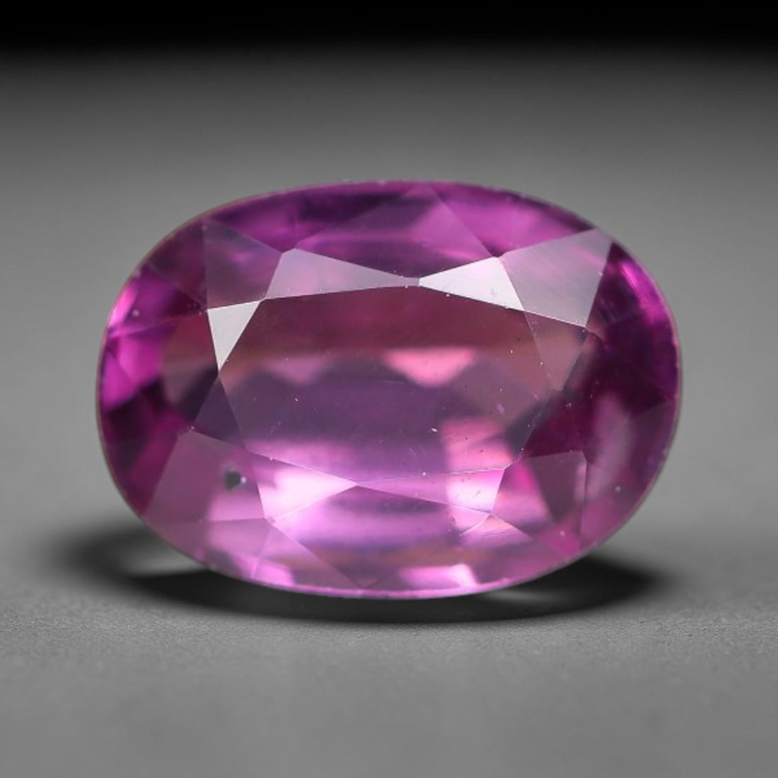 1.19ct Natural Tanzanian Rhodolite Grape Garnet Faceted Loose Gemstone, 83BF: This expertly faceted grape garnet, a scarce saturated purple-magenta rhodolite variant, features transparent crystal structure dotted with faint microscopic mineral specks within its precisely cut re