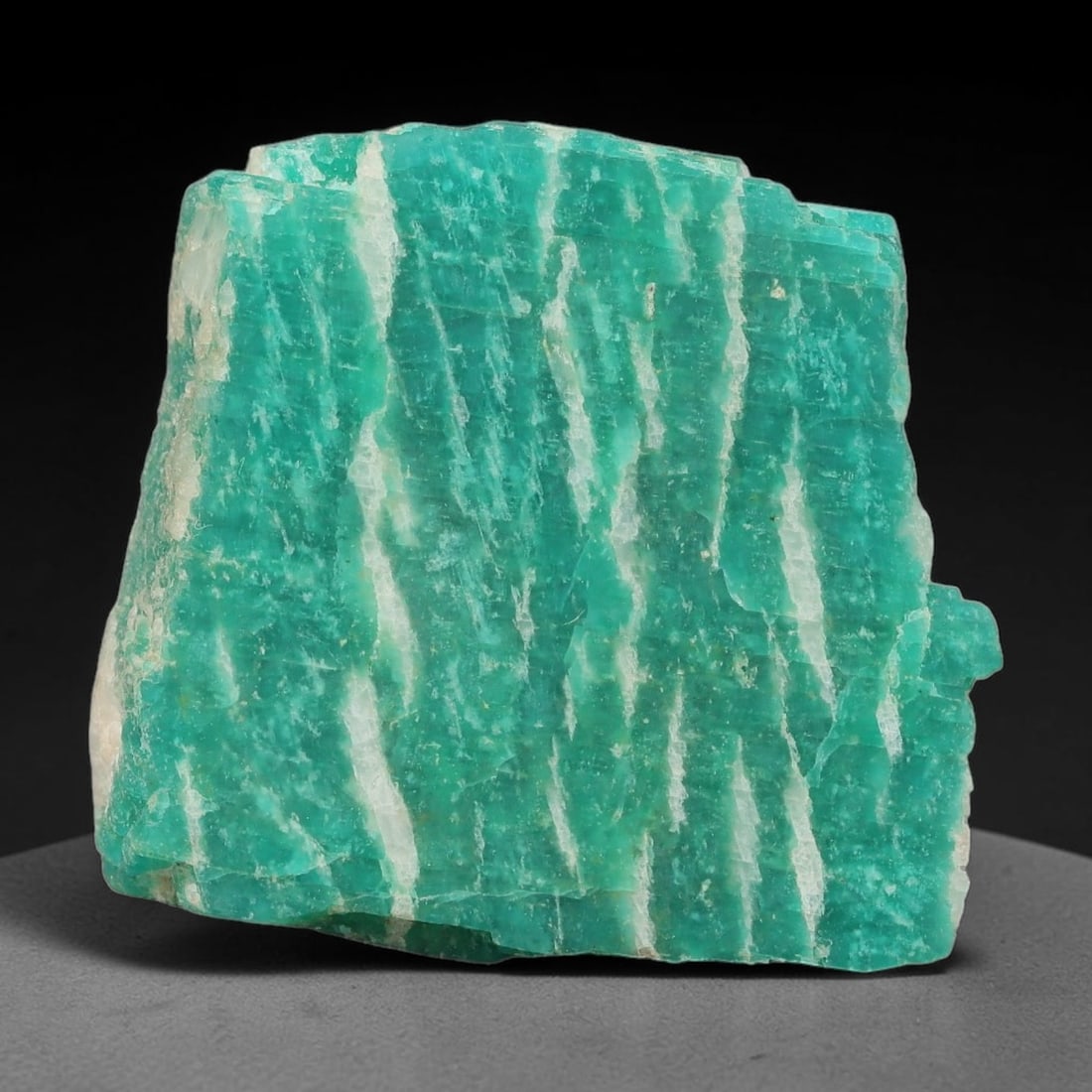 75ct Natural Russian Ural Amazonite Slab Rough, 79EB: This intact amazonite slab features distinct parallel mineral banding running uniformly across its naturally split flat surface within 32x30x8mm slab dimensions, retaining unmodified natural geologica