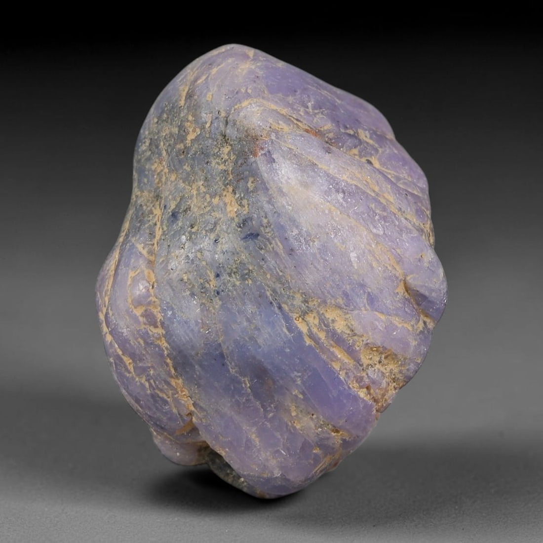 57.16ct Natural Unheated Sri Lankan Purplish Blue Sapphire Rough, 35FC: This natural corundum rough is an unheated purplish blue sapphire sourced from Sri Lankan alluvial gem deposits, featuring an irregular natural native form with residual pale yellow-brown mineral matr