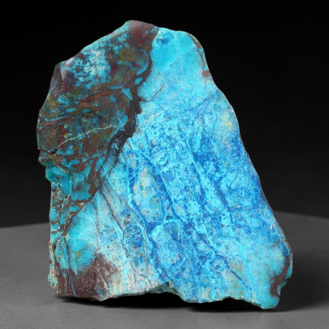 125ct Natural Peruvian Chrysocolla Polished Slab Rough, 74AR: This partial-polished chrysocolla slab features blended mineral matrix with smooth refined face and unaltered natural rugged edge across its 35x29x21mm elongated form, translucent mineral layers hold 