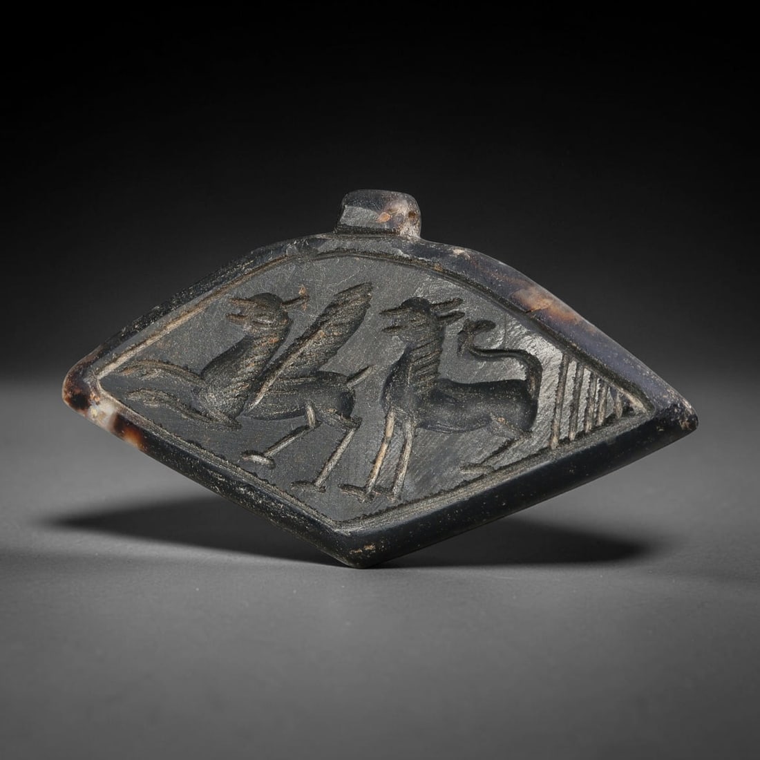 Vintage Banded Stone Sasanian Revival Dual Zoomorphic Glyptic Talisman Amulet Pendant, 15FK: This carved stone talisman pendant is crafted in revival style drawing inspiration from classic Sasanian glyptic art. The diamond-shaped plaque features intricately incised paired mythical zoomorphic 