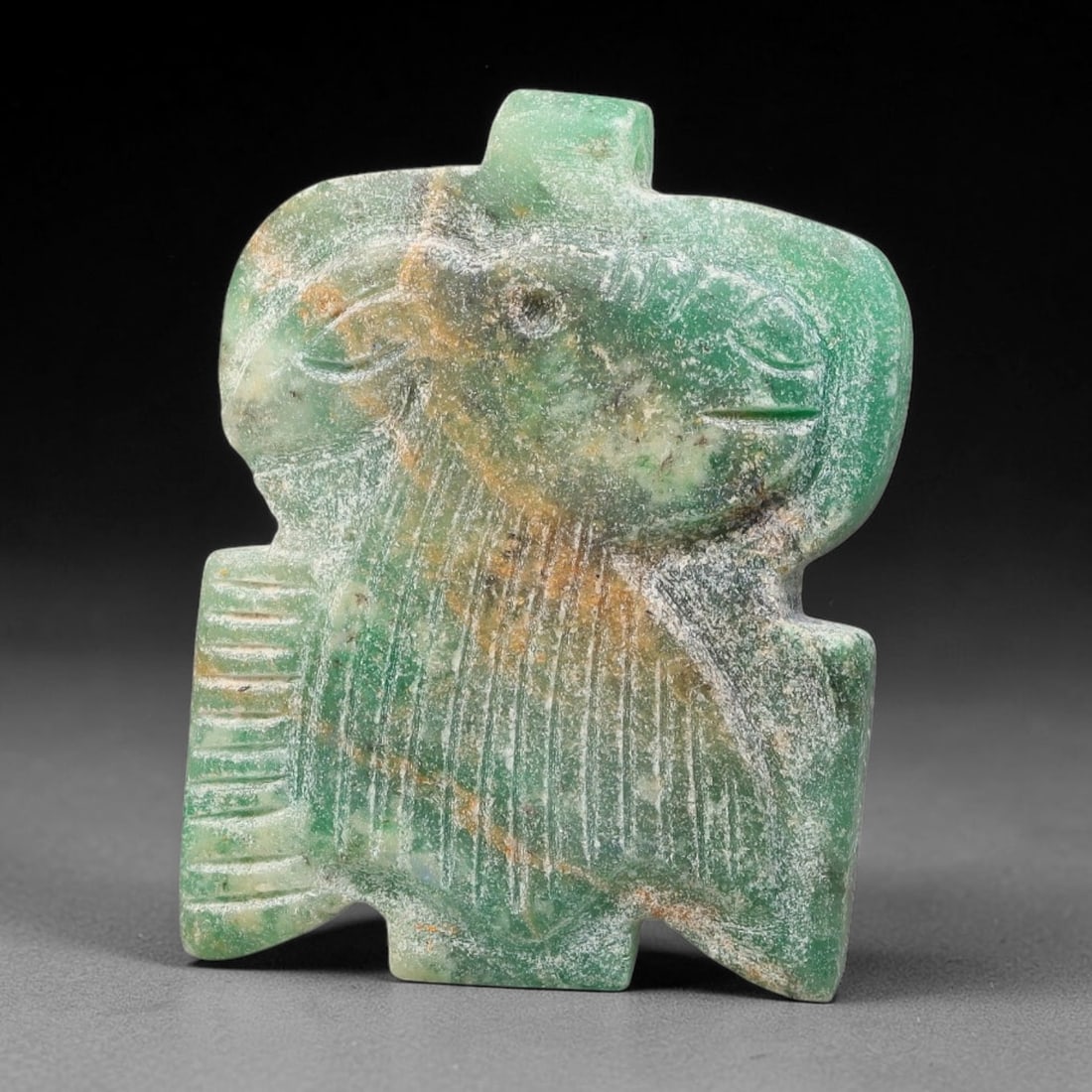 Vintage Green Stone Sasanian Revival Zoomorphic Head Talisman Amulet Plaque, 3FL: This vintage carved stone amulet plaque is crafted in revival style inspired by Sasanian glyptic traditions. The green mineral stone features finely incised detailing depicting a stylised animal head 