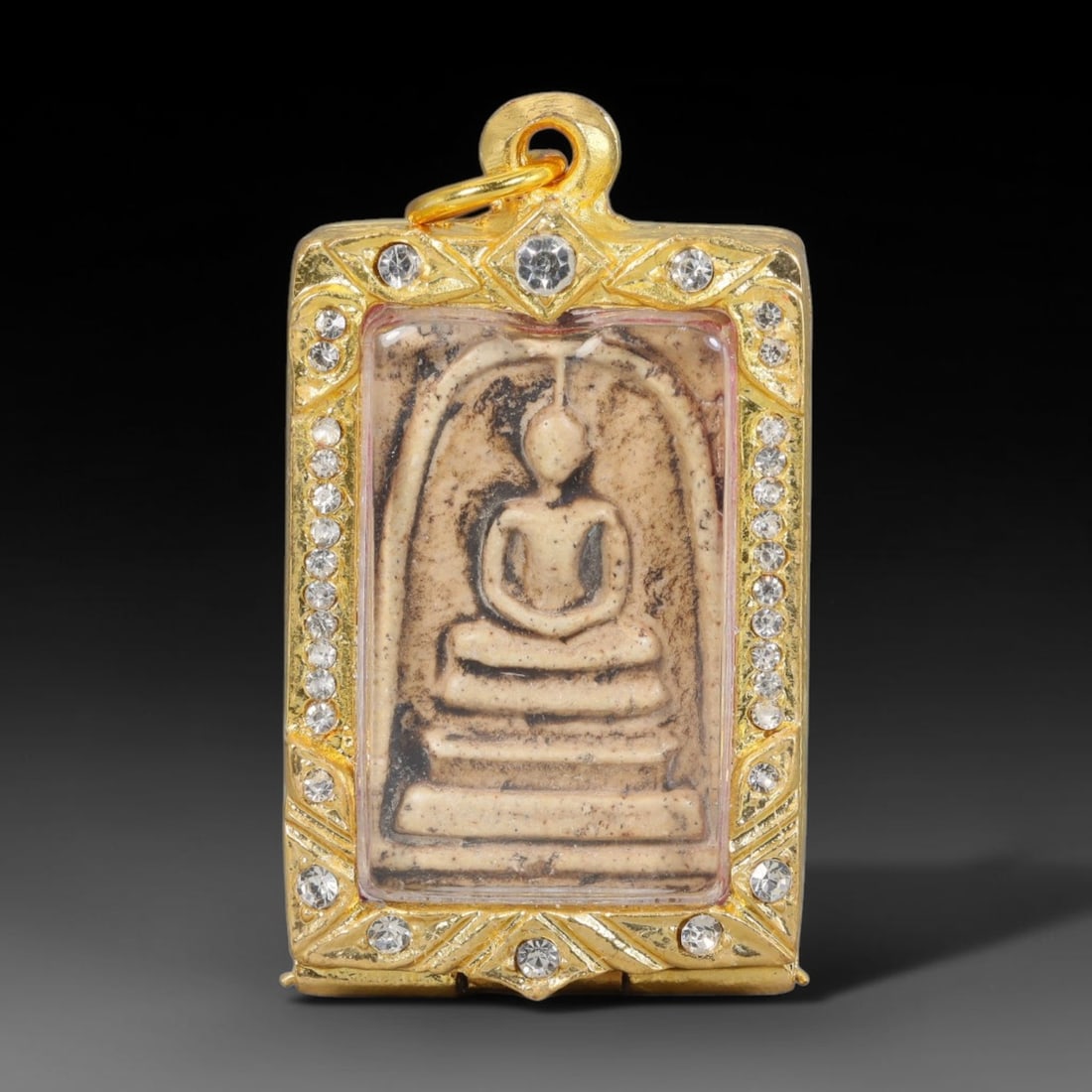 Thai Buddhist Folk Tradition Enclosed Amulet Pendant with Decorative Metal Casing, 7AH: This Thai sacred amulet is housed within an ornate hinged metal protective casing fitted with a top loop for wear as a pendant. The casing features intricate embossed surface detailing and a continuou