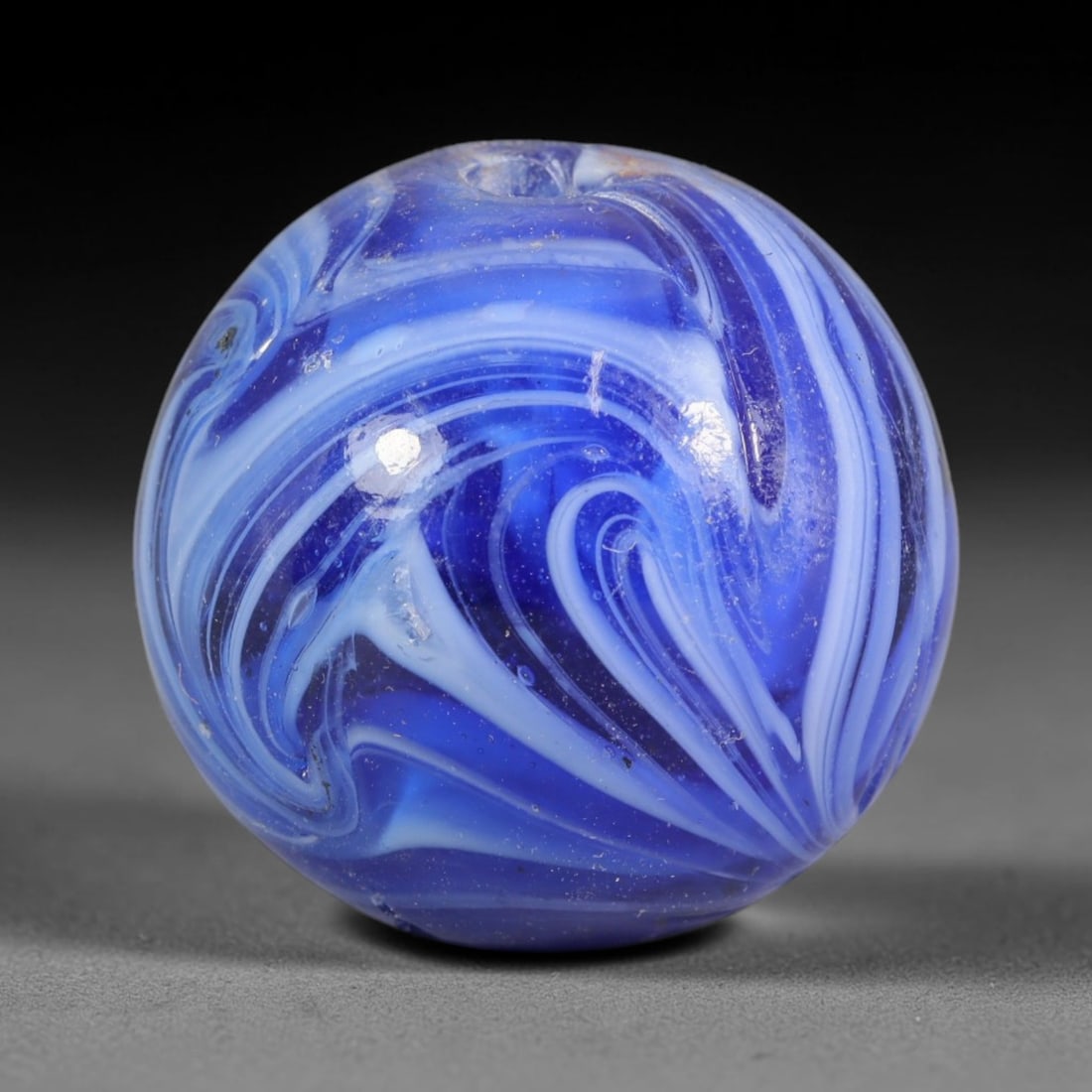 Swirled Blue Blown Glass Bead - Handmade Vintage Spherical Ornament, 20AE: Hand-blown glass construction forms this perfectly spherical bead, featuring layered swirling bands of deep cobalt blue, pale sky blue and opaque white glass that flow in continuous marbled striations